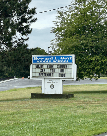 big sign on grass lawn reading "goff middle school"