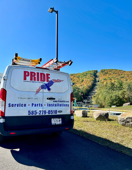 Pridecas truck parked in a lot with a ski mountain in the background