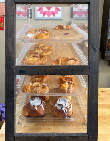 assortment of bakery goods inside a display case